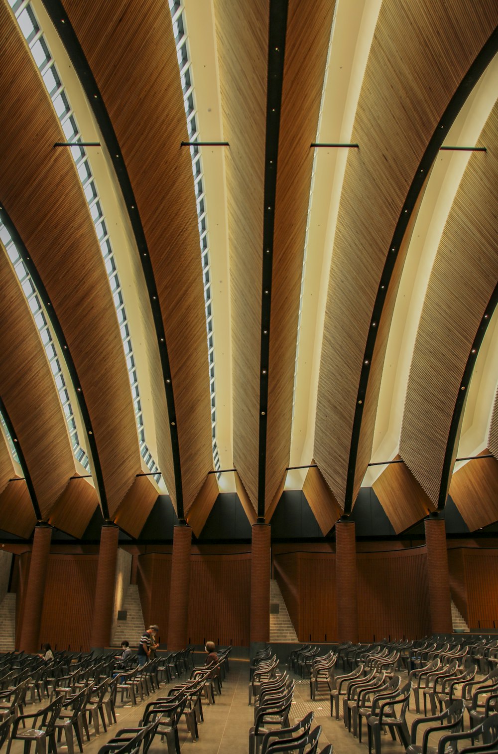 the ceiling of a large auditorium with rows of chairs