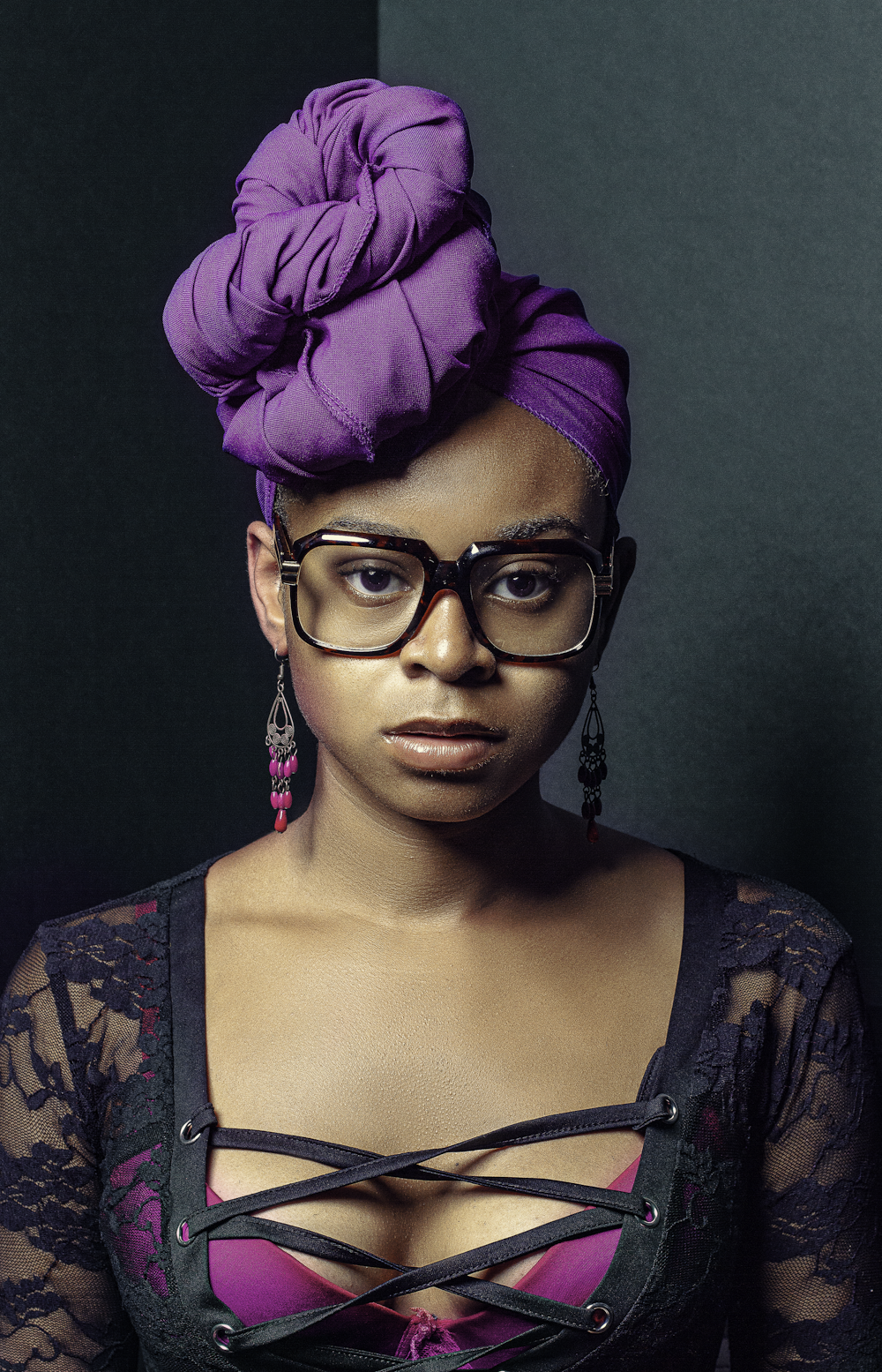 a woman wearing glasses and a purple hat