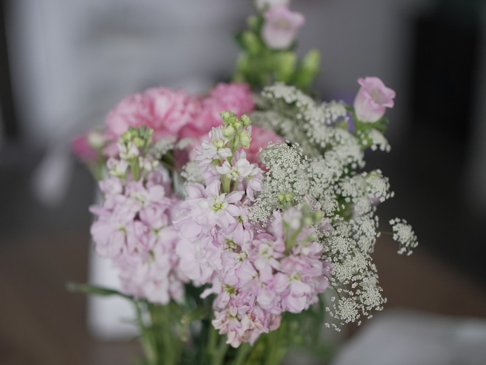 a vase filled with pink and white flowers