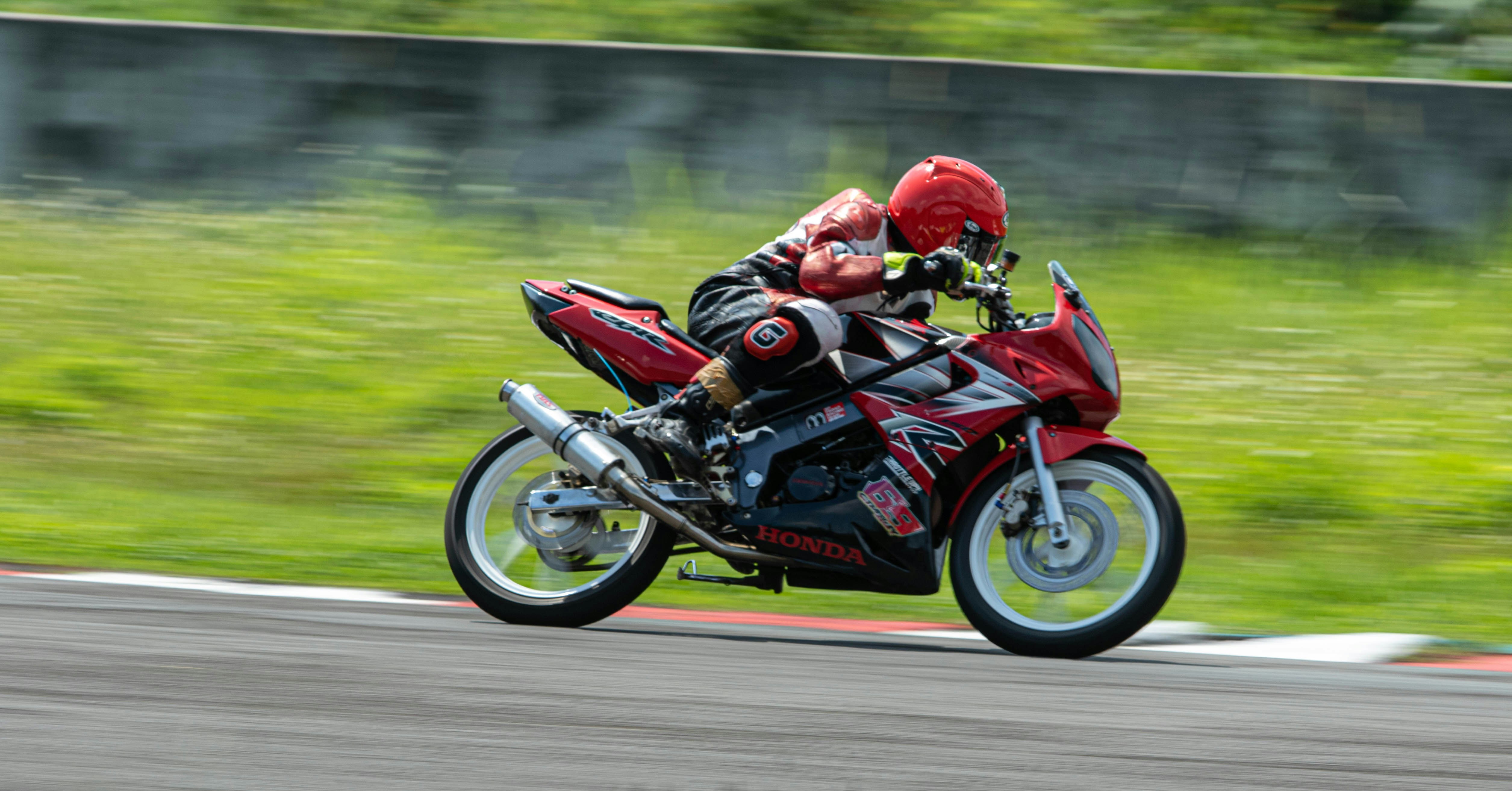 Sport motorcycle braking hard on a race track corner during a track day
