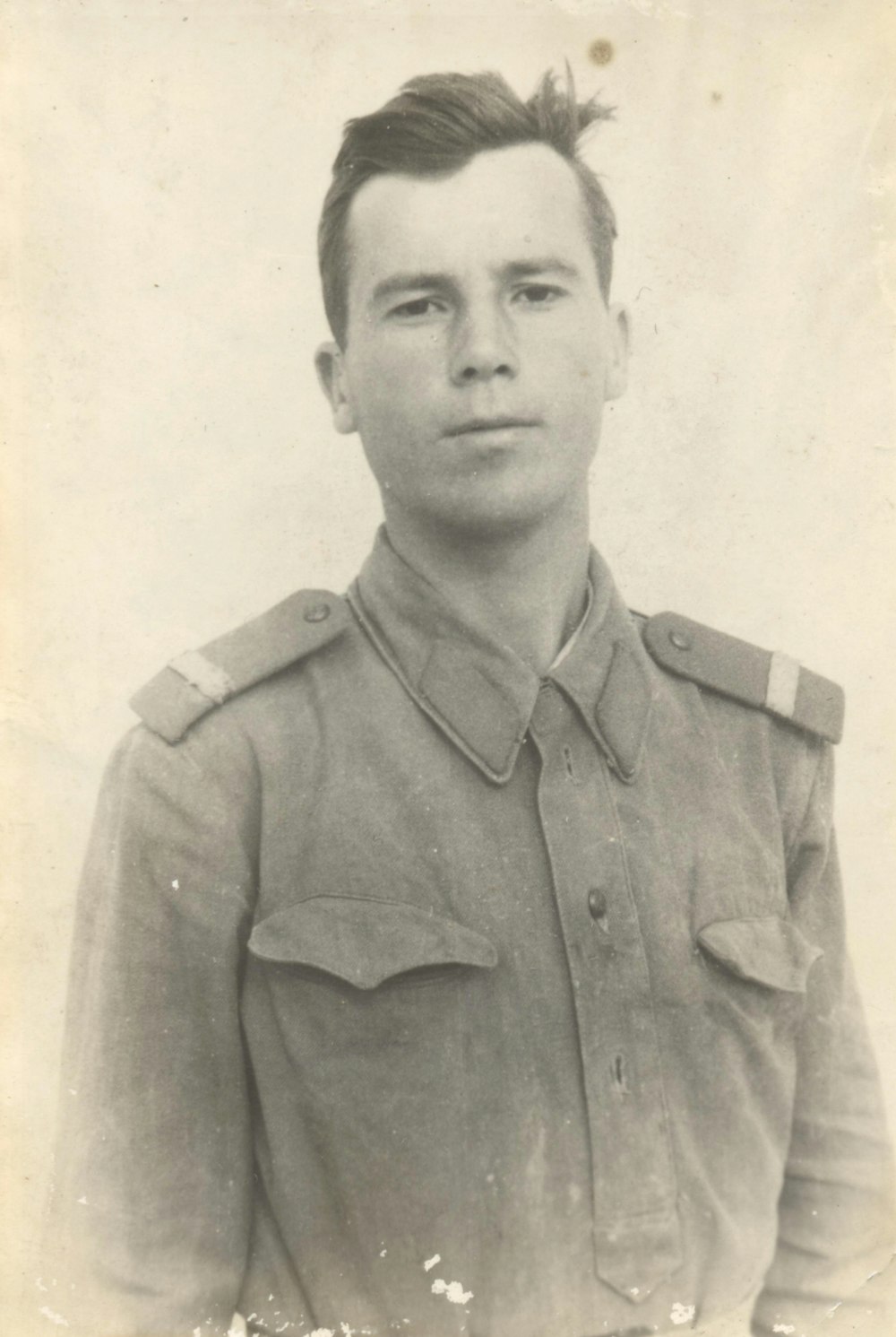 a black and white photo of a man in uniform
