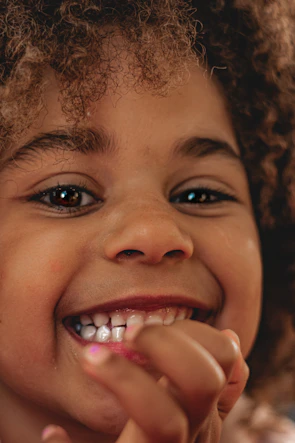 Close-up of a child smiling during an eye checkup at a friendly clinic.