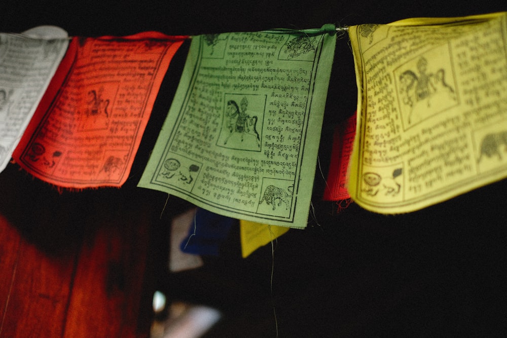 a row of colorful paper banners hanging from a line