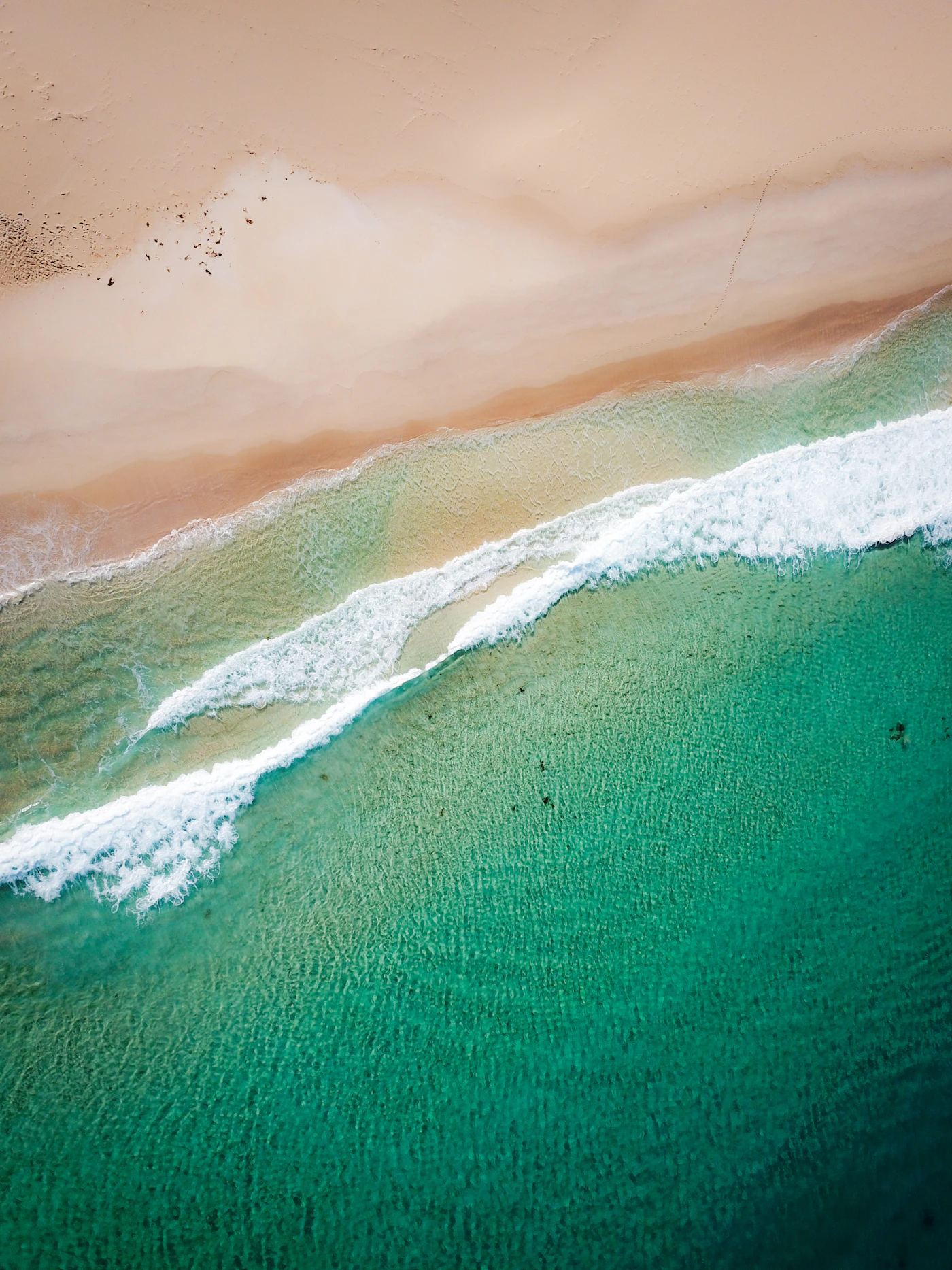 Aerial view of a white beach and turquoise water on the Western Australian coast