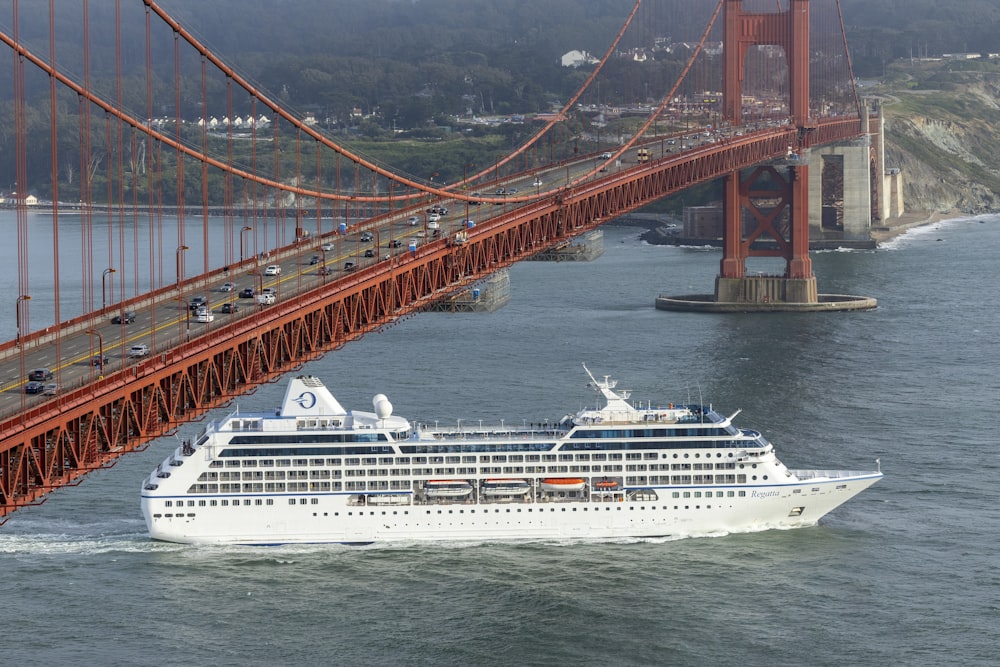 a cruise ship sailing under the golden gate bridge