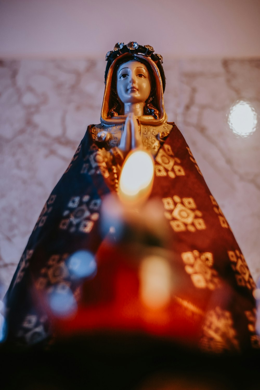 a statue of a woman with a candle in her hand