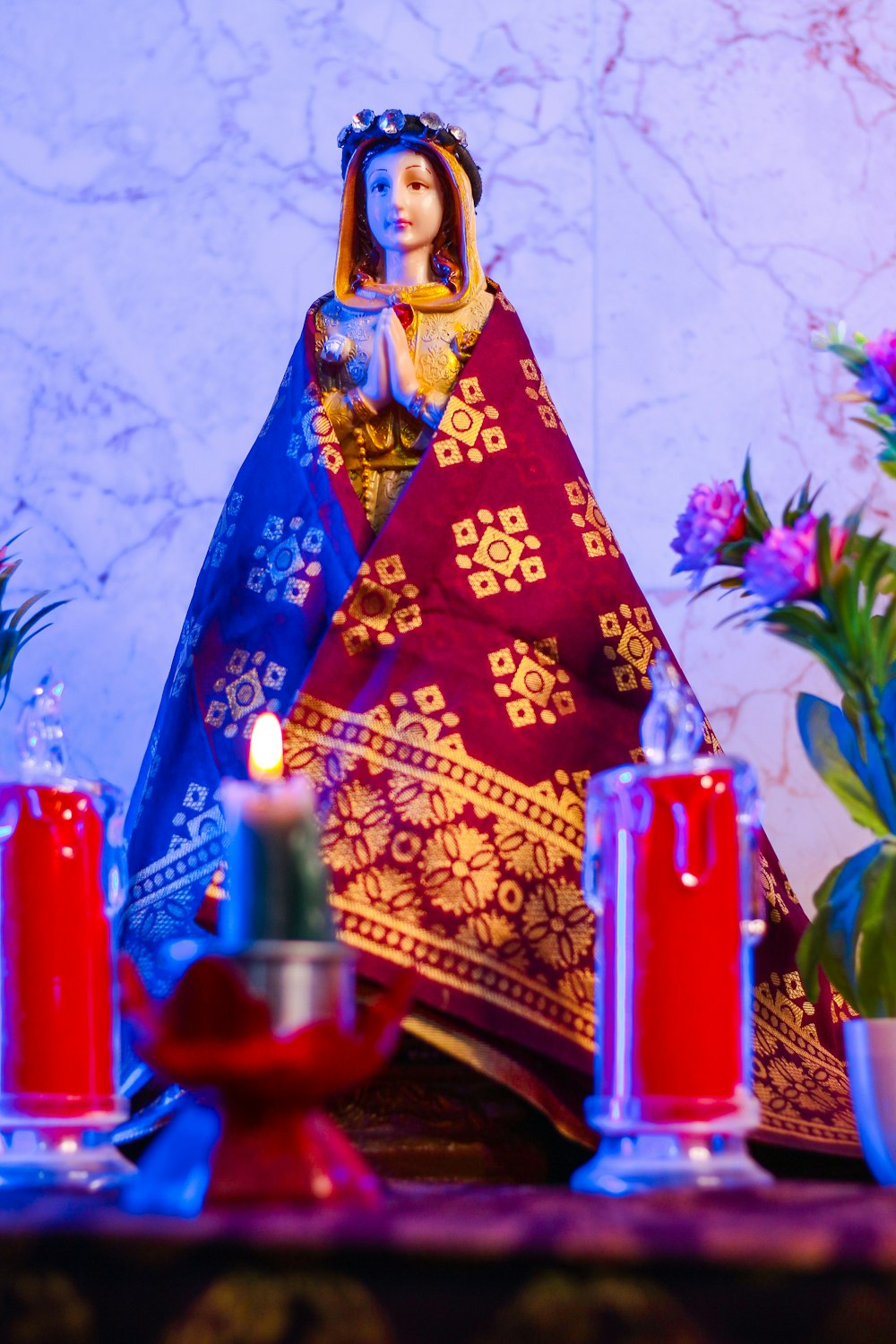 a figurine of a woman in a blue and red dress