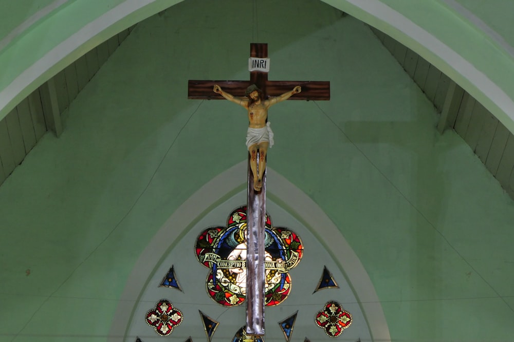 a crucifix in a church with stained glass windows