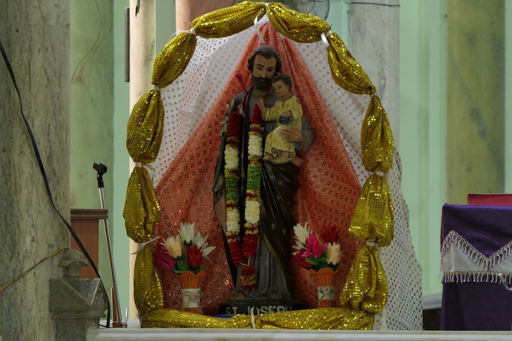 a statue of a man and a woman in a shrine