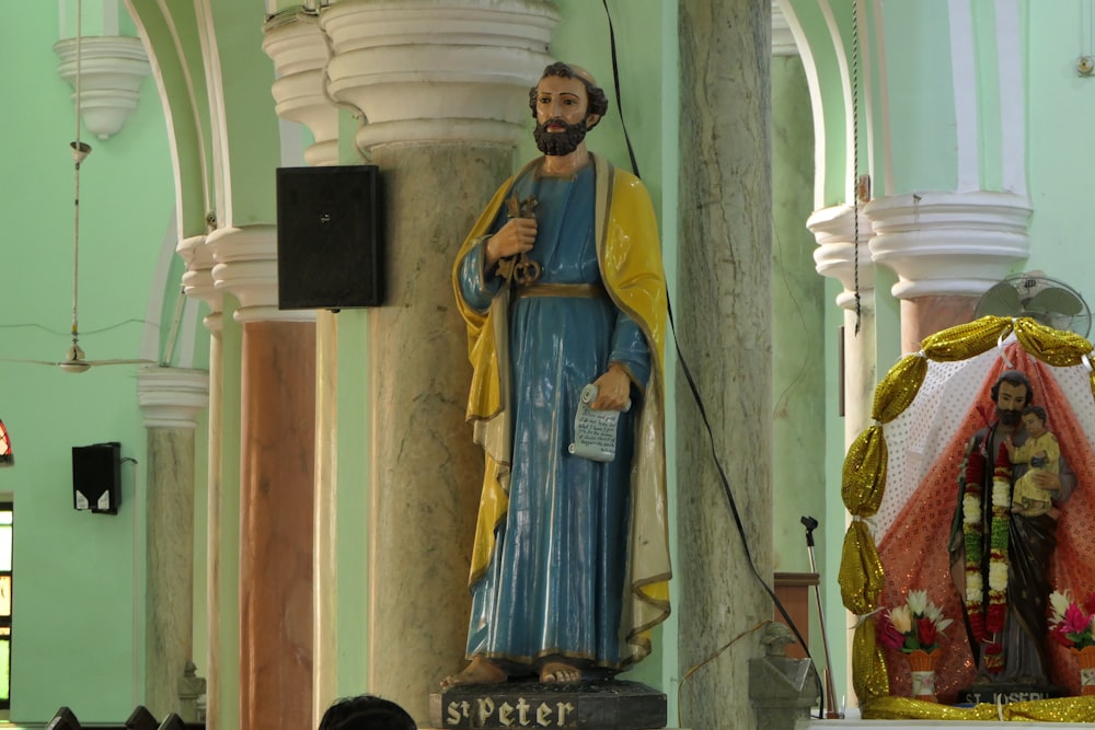 a statue of jesus in a church next to a speaker
