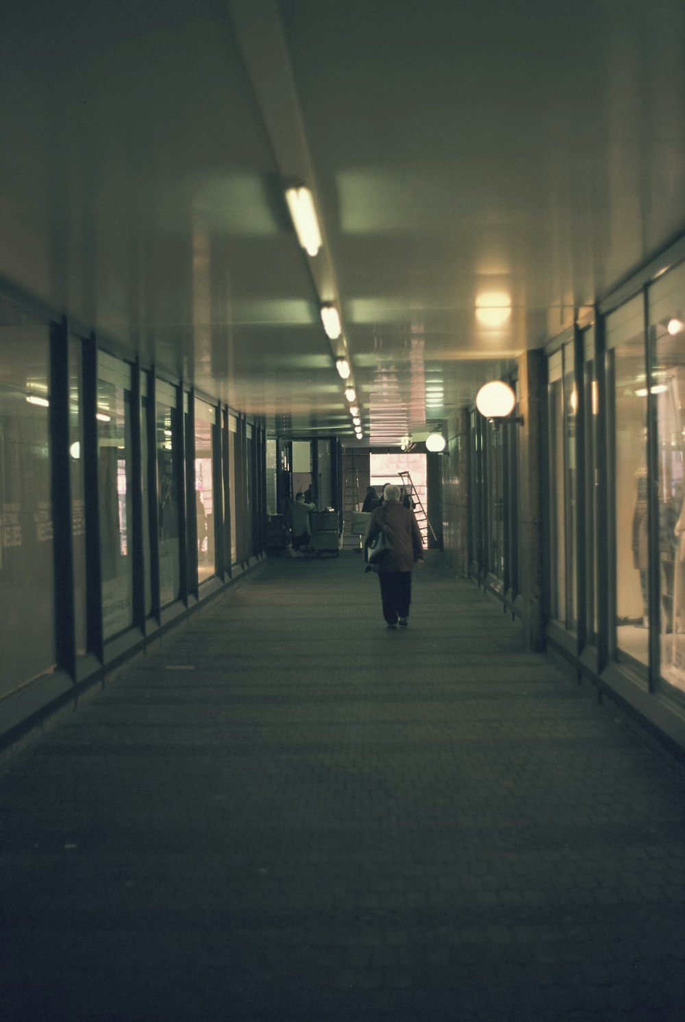 a person walking down a hallway in a building