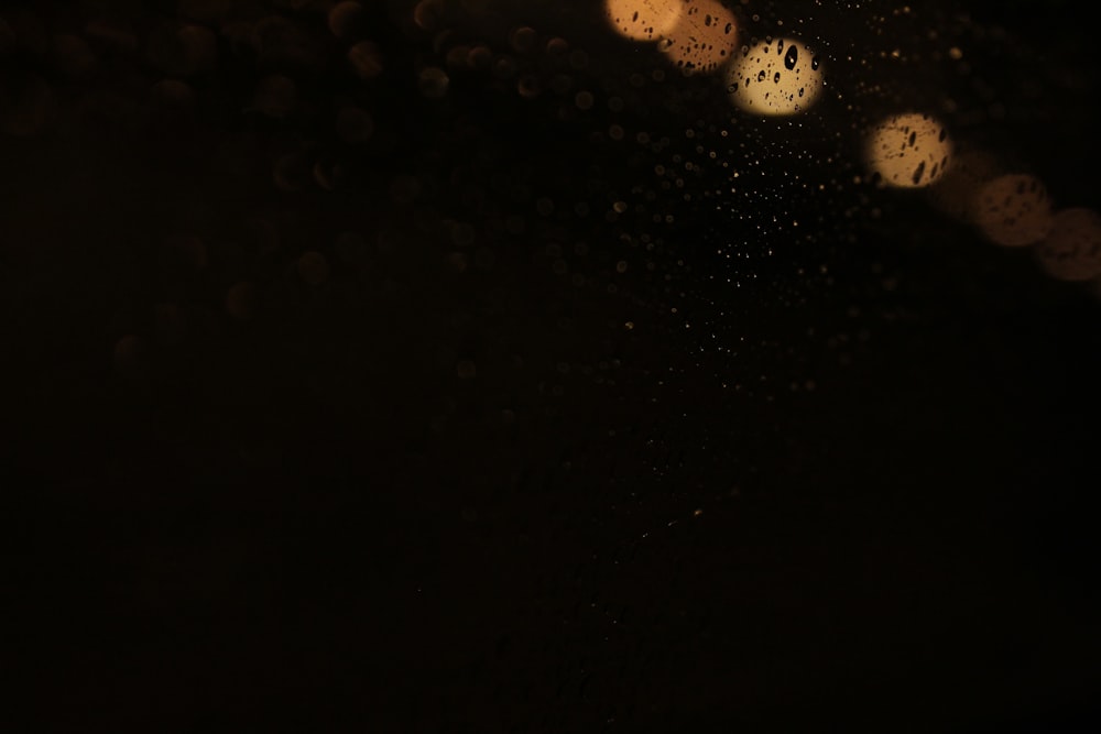 rain drops on the window of a car at night
