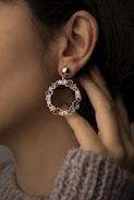 a close up of a person wearing a pair of earrings