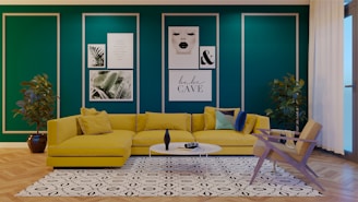 a living room with green walls and a yellow couch