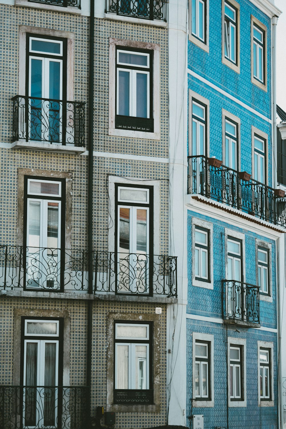 a blue and white building with balconies and balconies