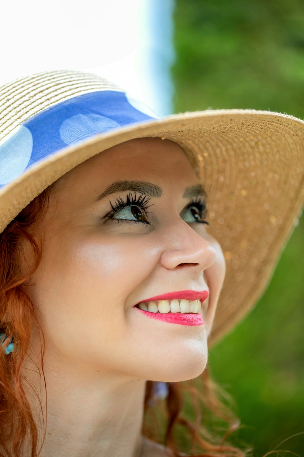 a woman wearing a straw hat and blue dress