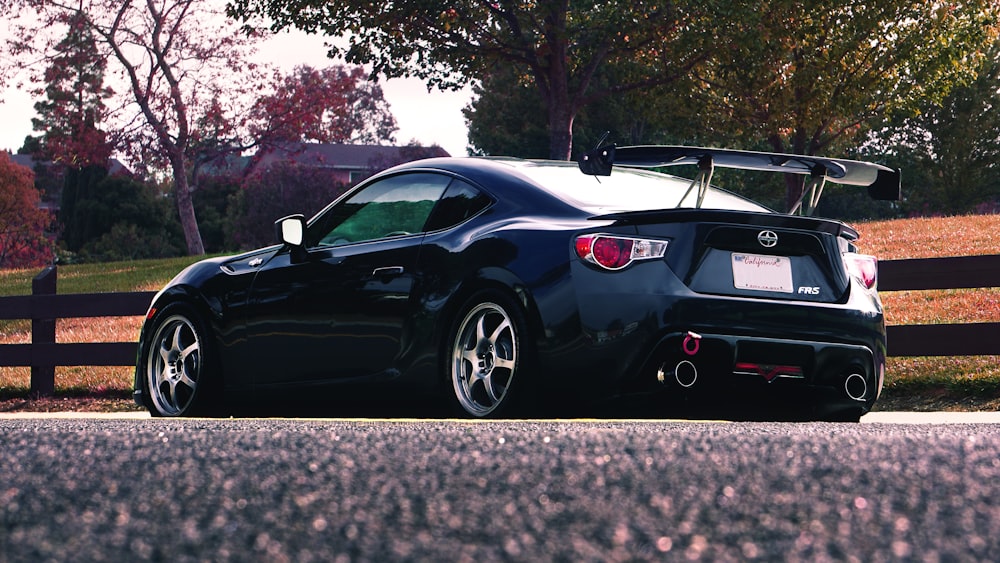 a black sports car parked on the side of the road