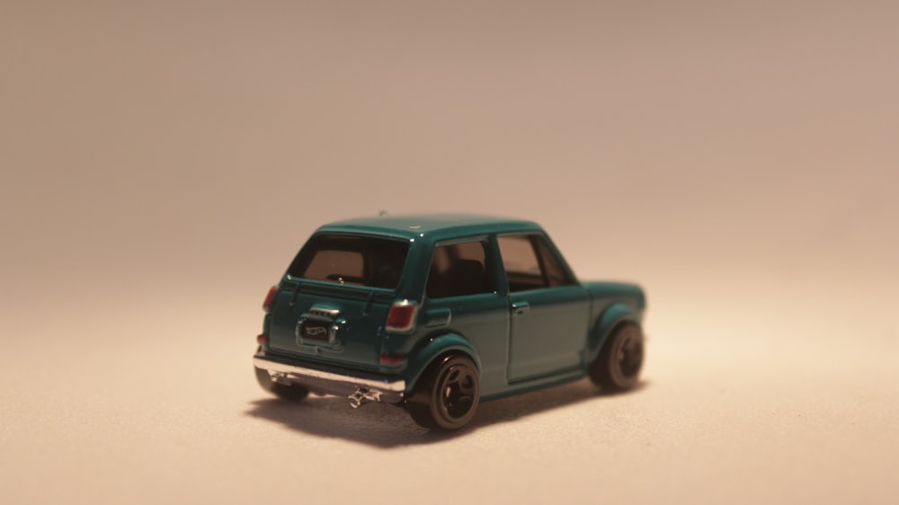 a small toy car on a white surface
