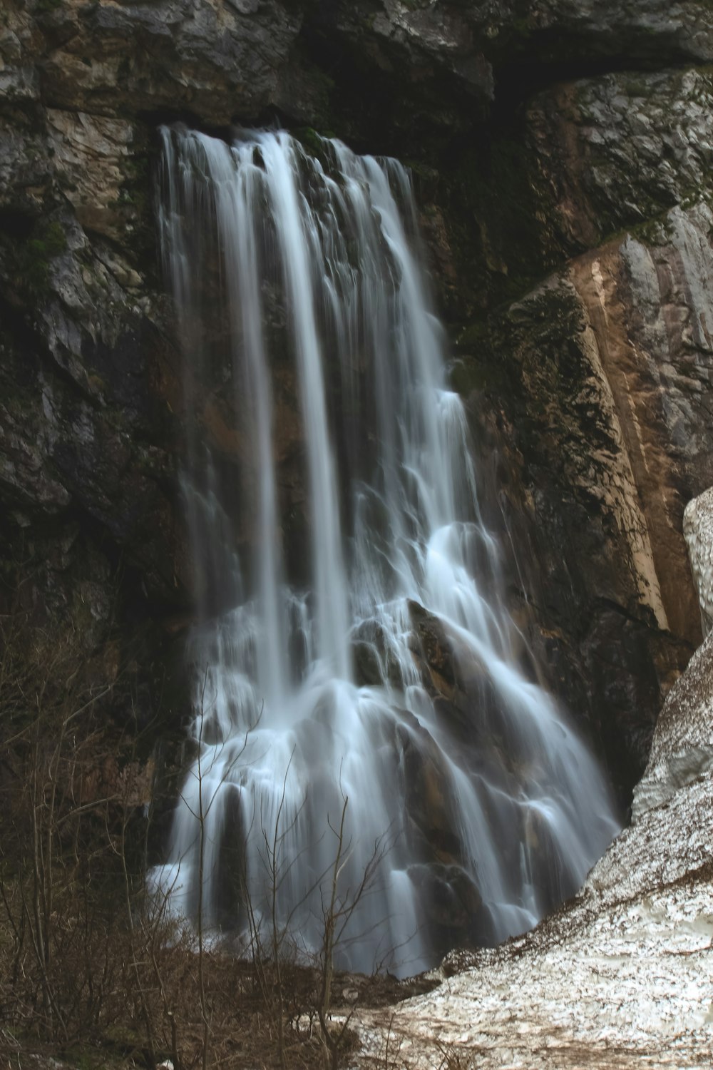 a large waterfall with water cascading down it's sides