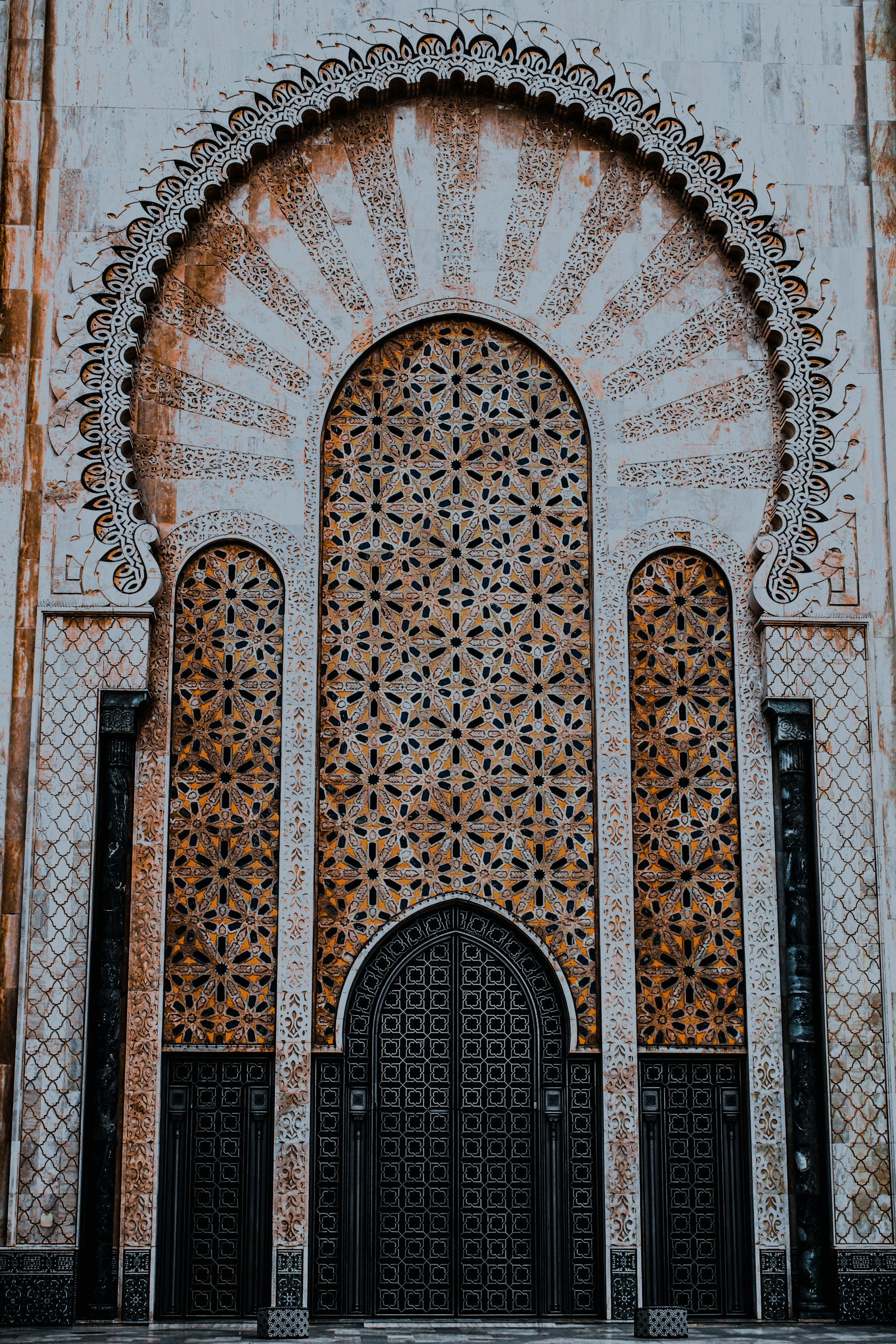 a building with a large metal door and intricate carvings