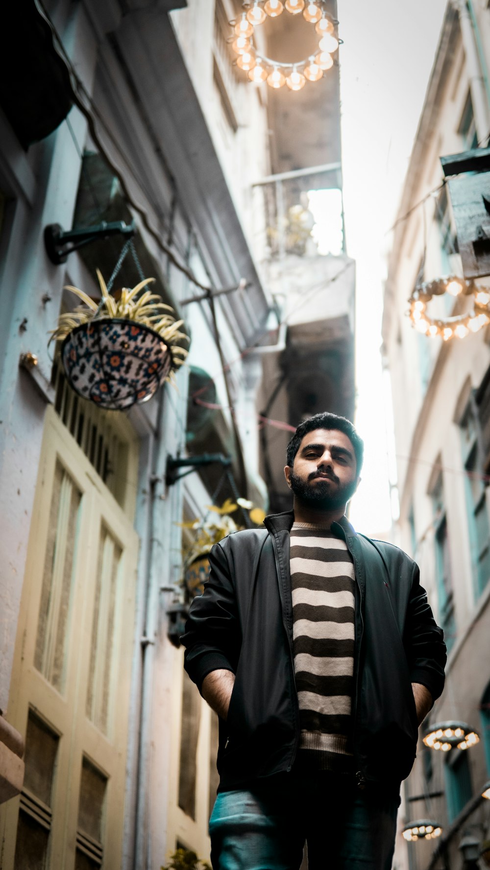 a man standing in a narrow alley way