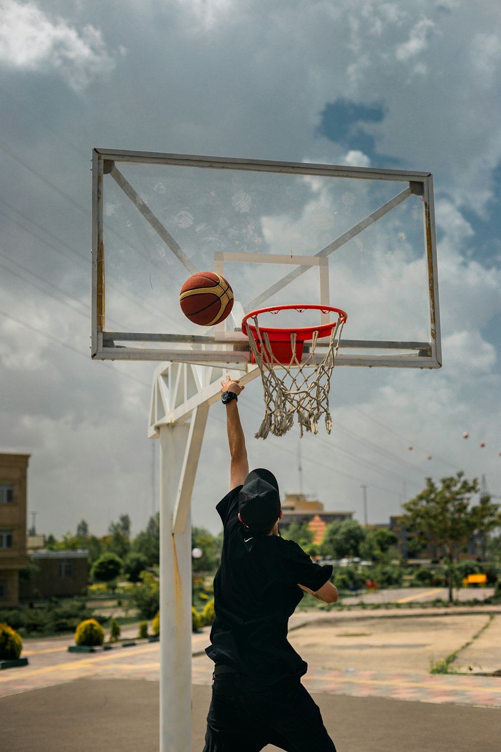 a man dunking a basketball into a basketball hoop