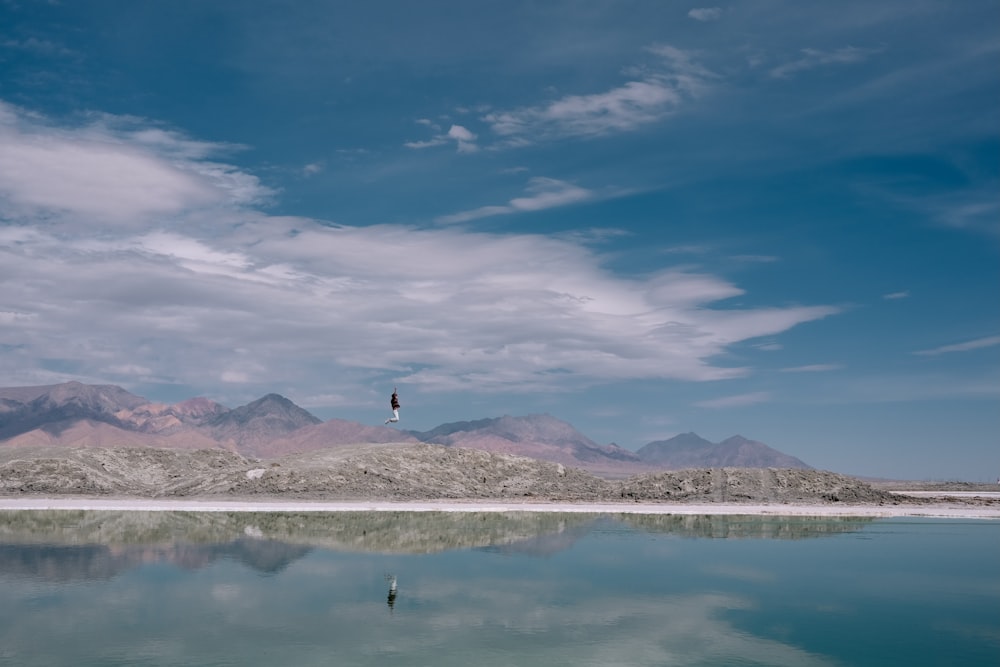 a large body of water with mountains in the background