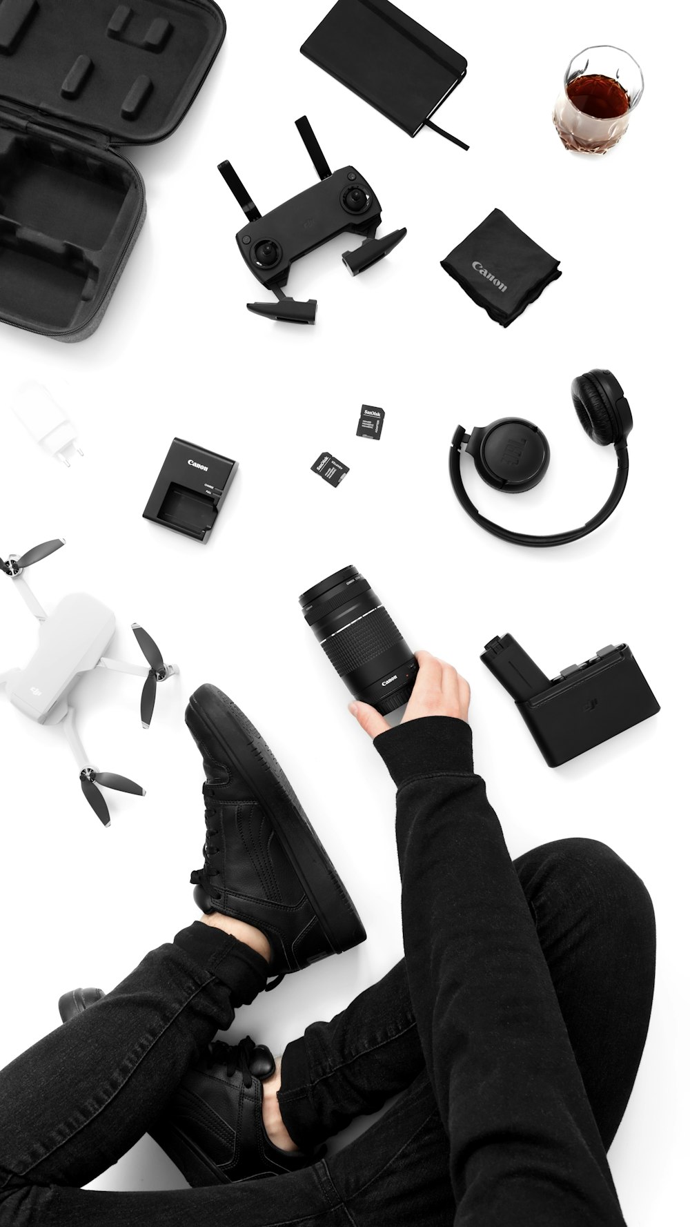 a person sitting on the ground surrounded by electronics