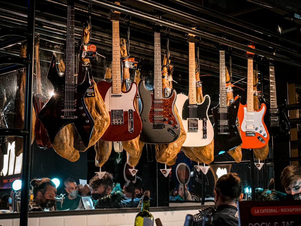 a group of guitars hanging from the ceiling