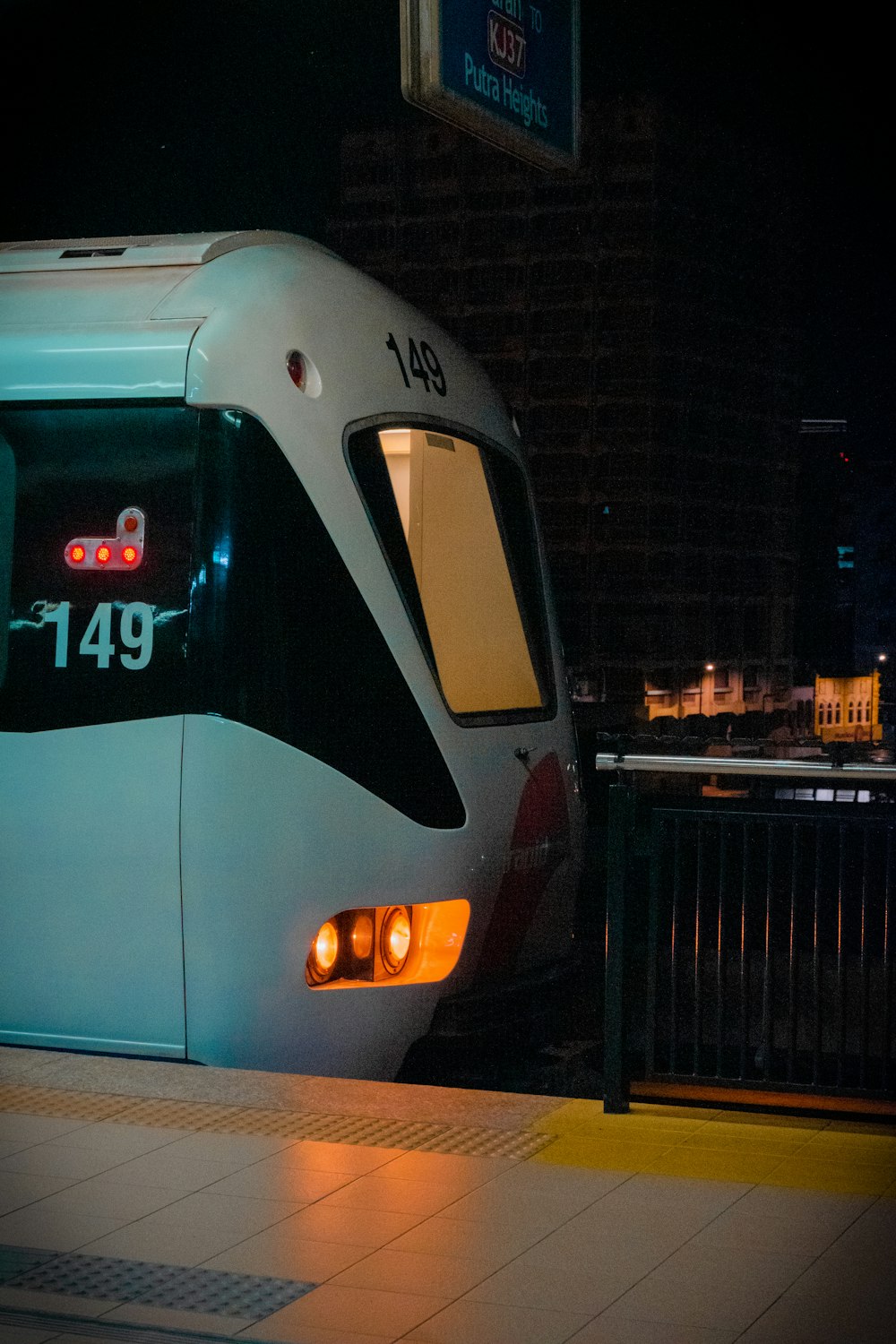 a subway train stopped at a station at night