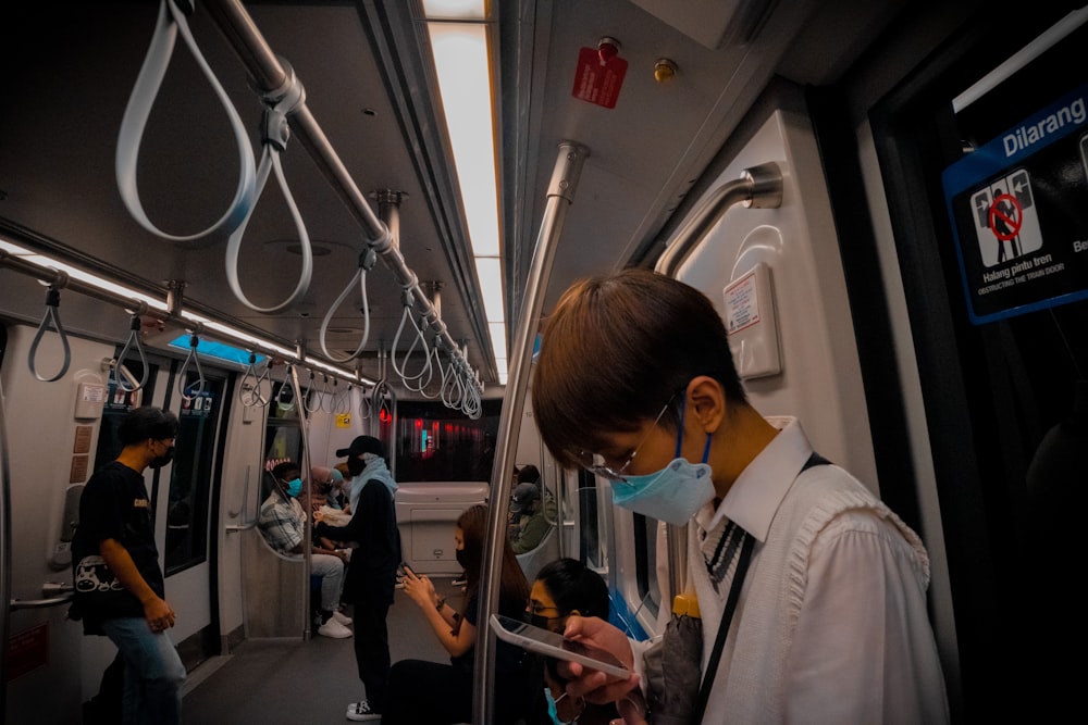 a man wearing a face mask on a train