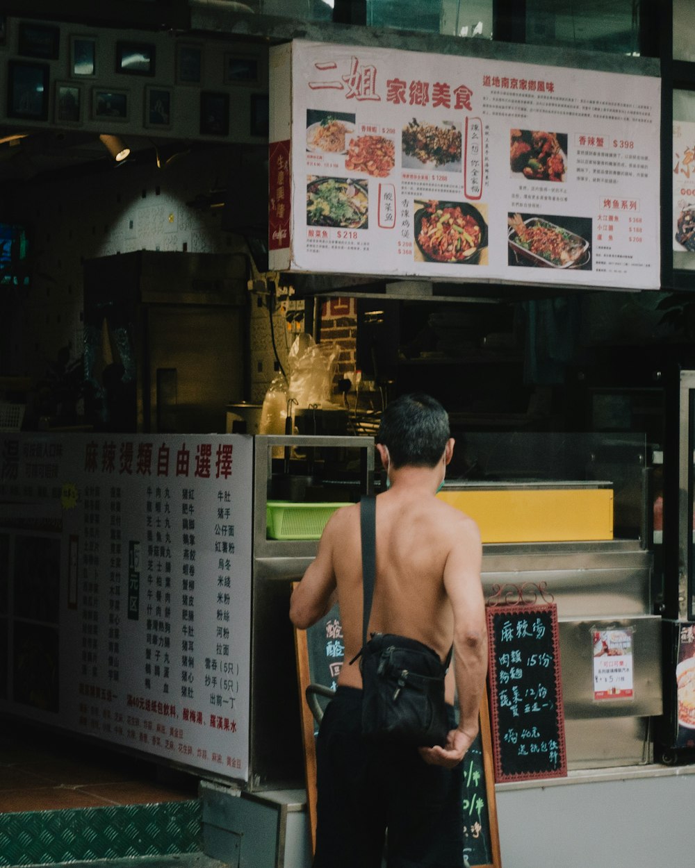 a man standing in front of a restaurant