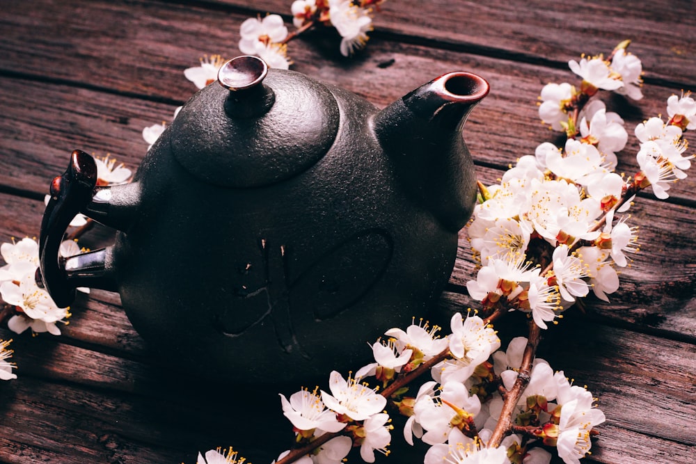 a teapot with a tea pot on top of a wooden table