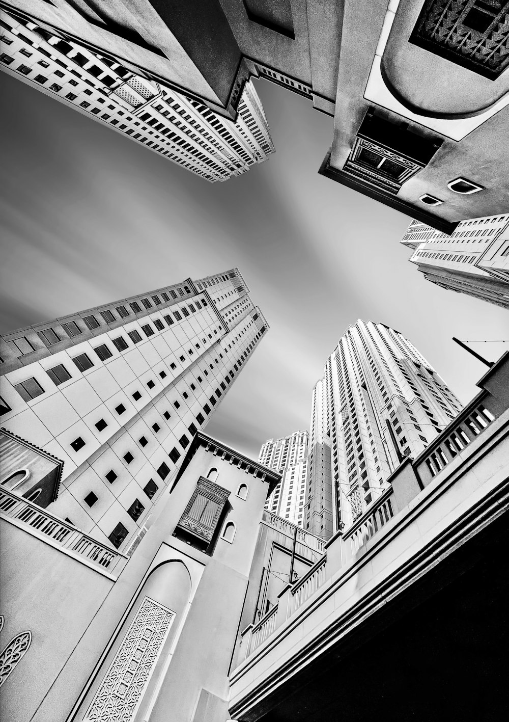 a black and white photo of tall buildings