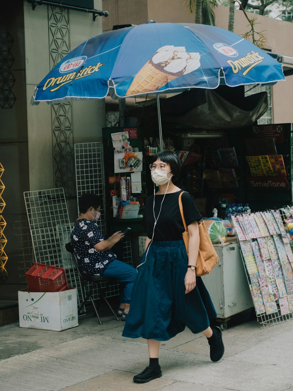 a woman with a face mask walking down the street