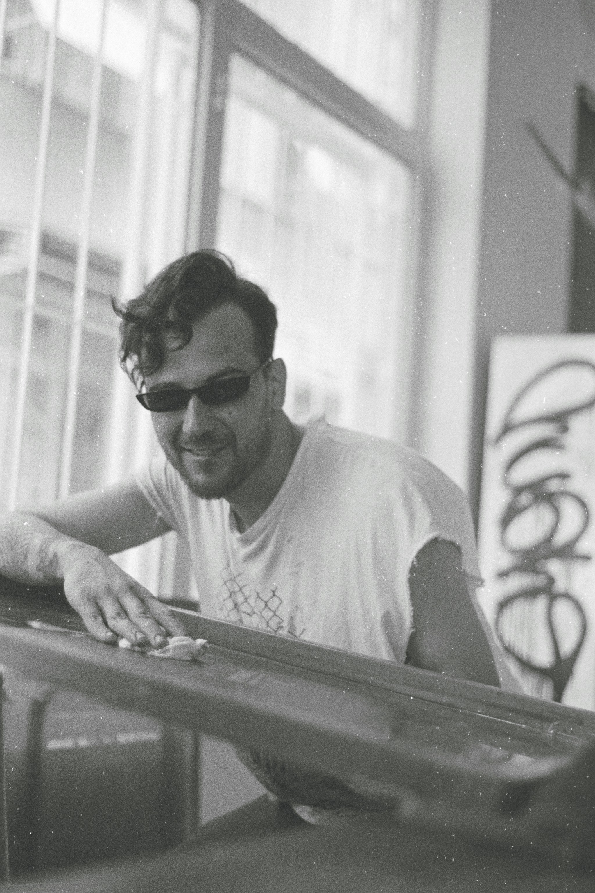 a man wearing sunglasses sitting at a table