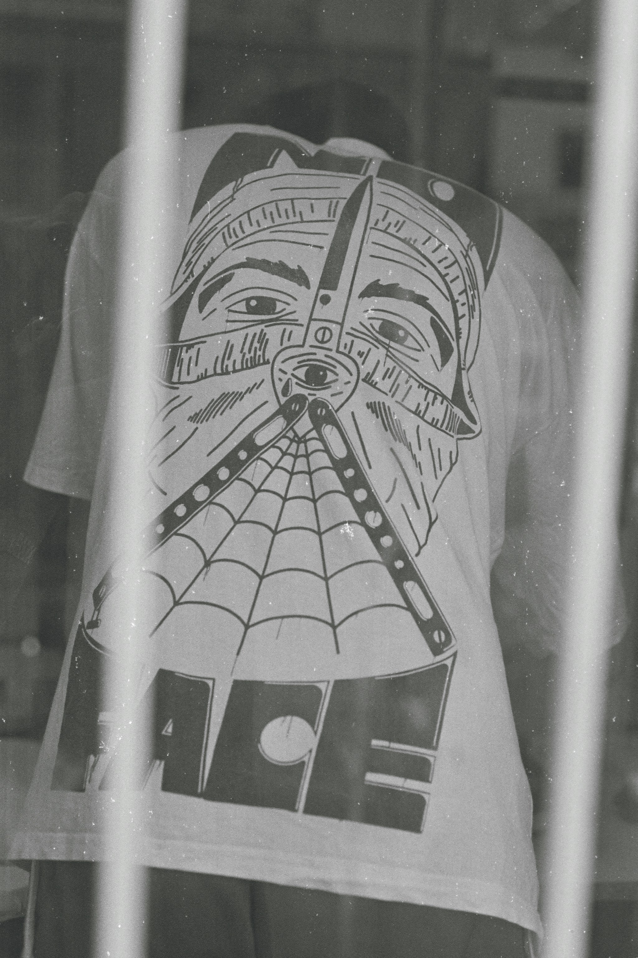 a black and white photo of a person behind bars