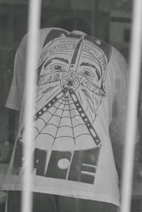 a black and white photo of a person behind bars