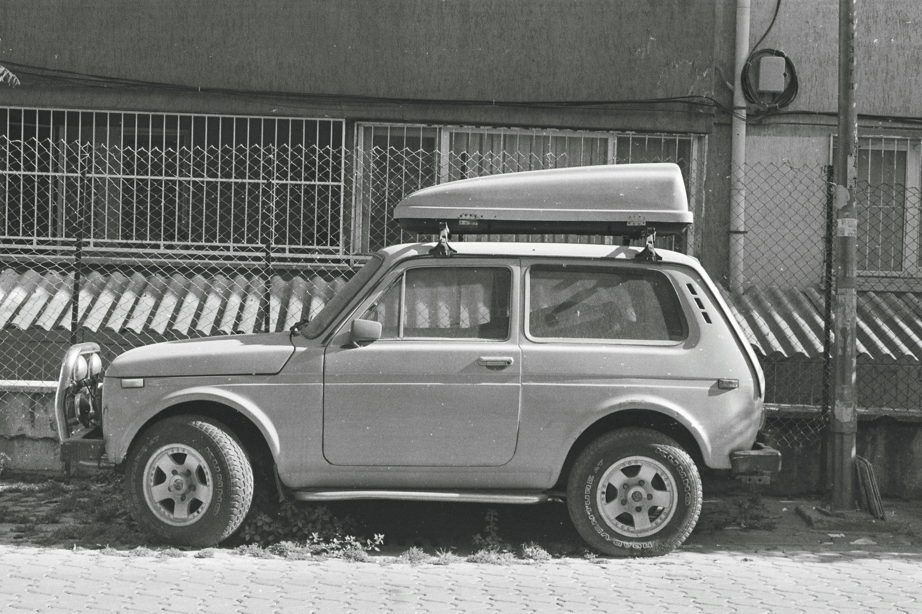a small car parked in front of a building
