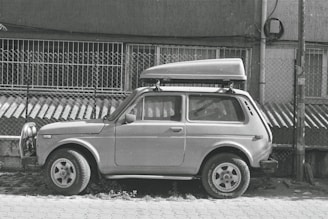 a small car parked in front of a building