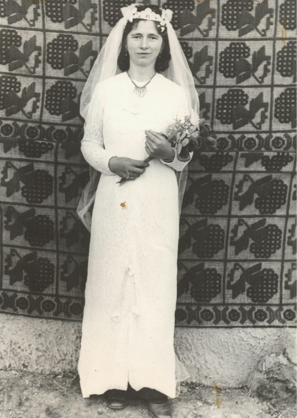 a black and white photo of a woman in a wedding dress