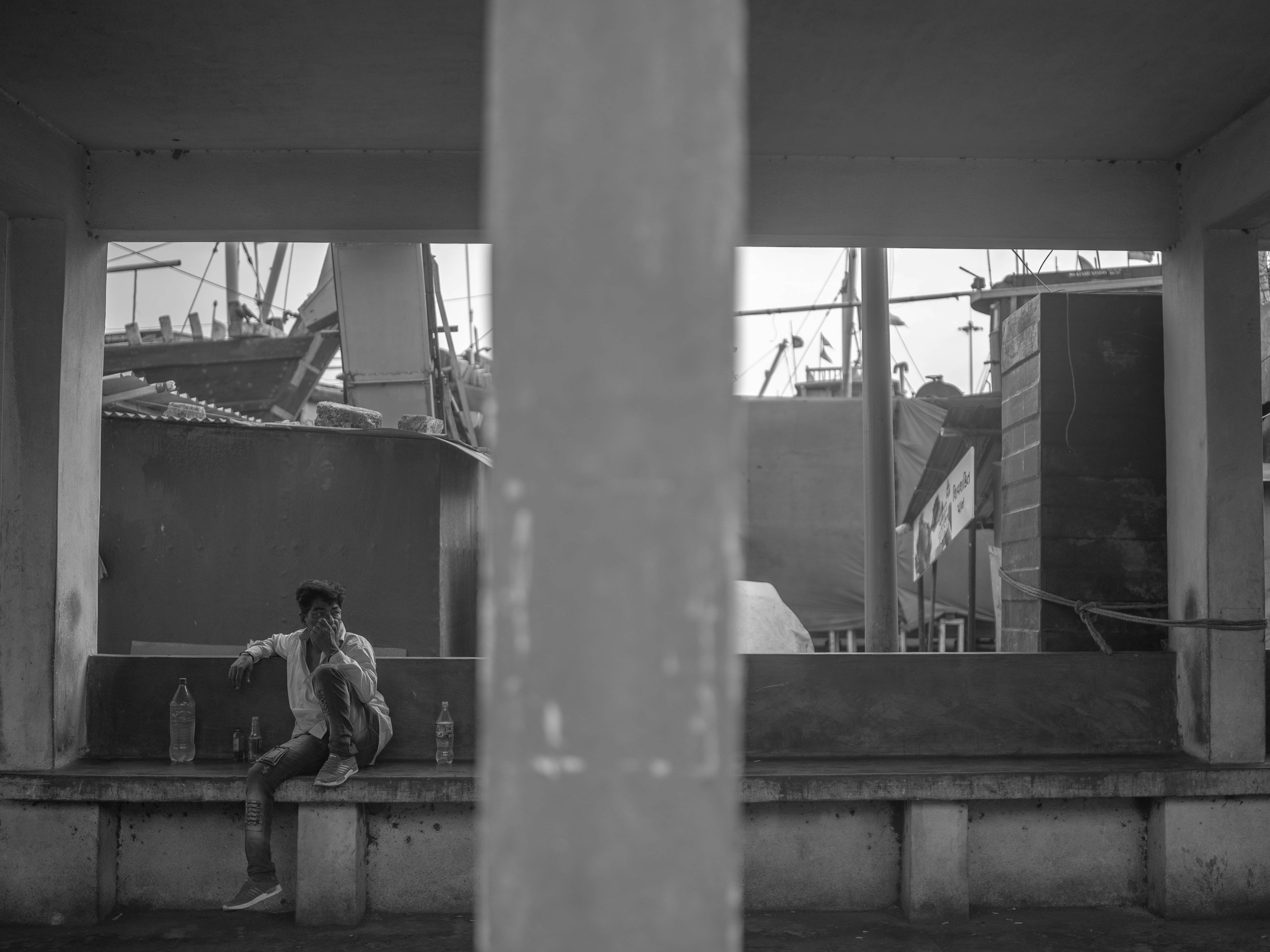 a man sitting on a bench in front of a building