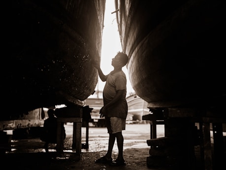 a man standing in front of a large boat