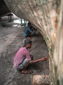 Close-up of marine growth being removed from a yacht hull by a skilled technician.
