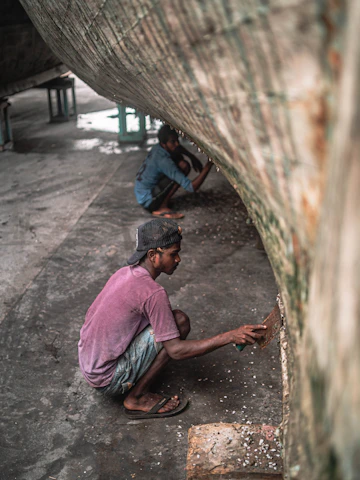Close-up of marine growth being removed from a yacht hull by a skilled technician.