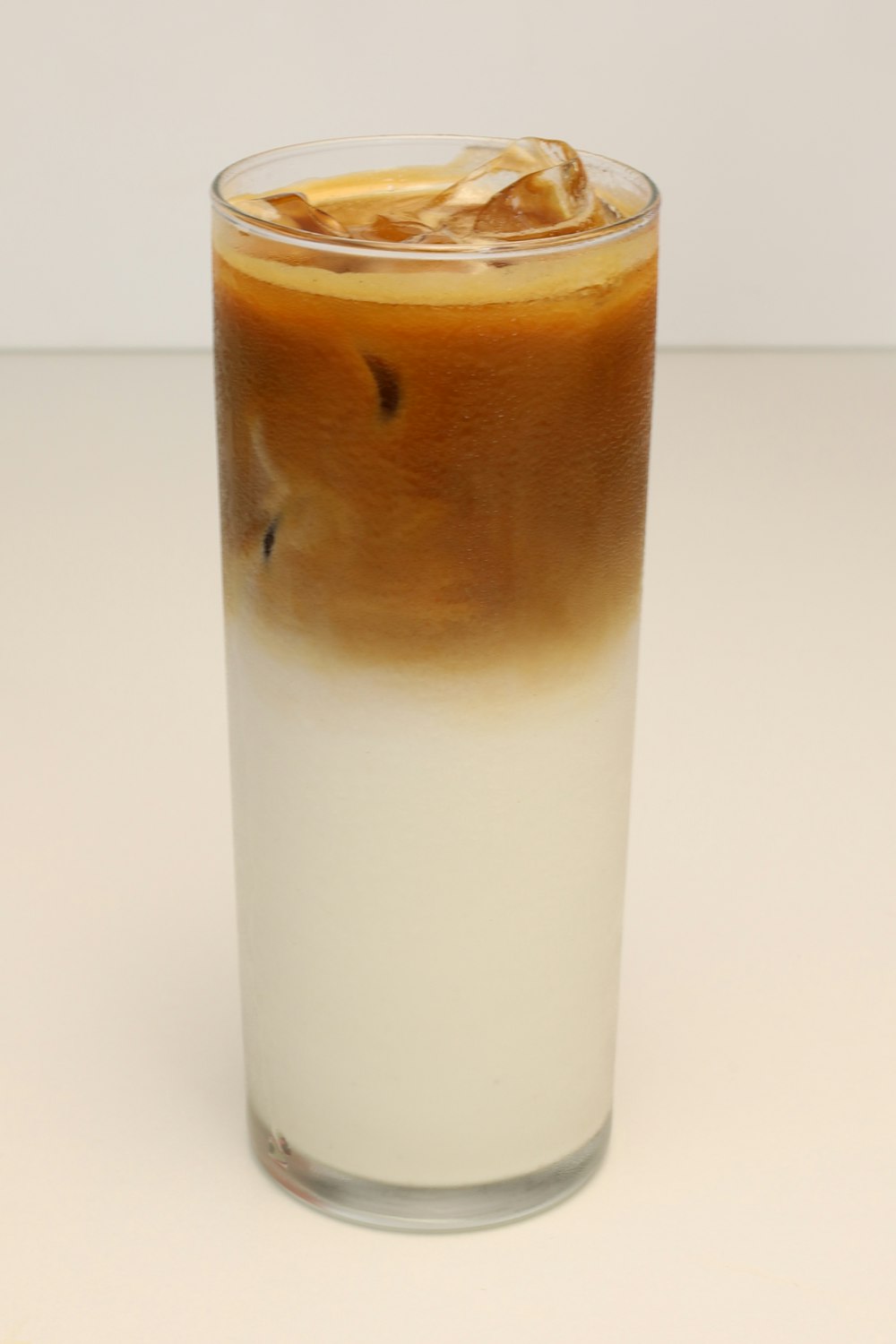 a tall glass filled with liquid and ice