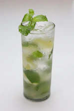 Refreshing mocktail in a tall glass with mint leaves and a slice of lime.