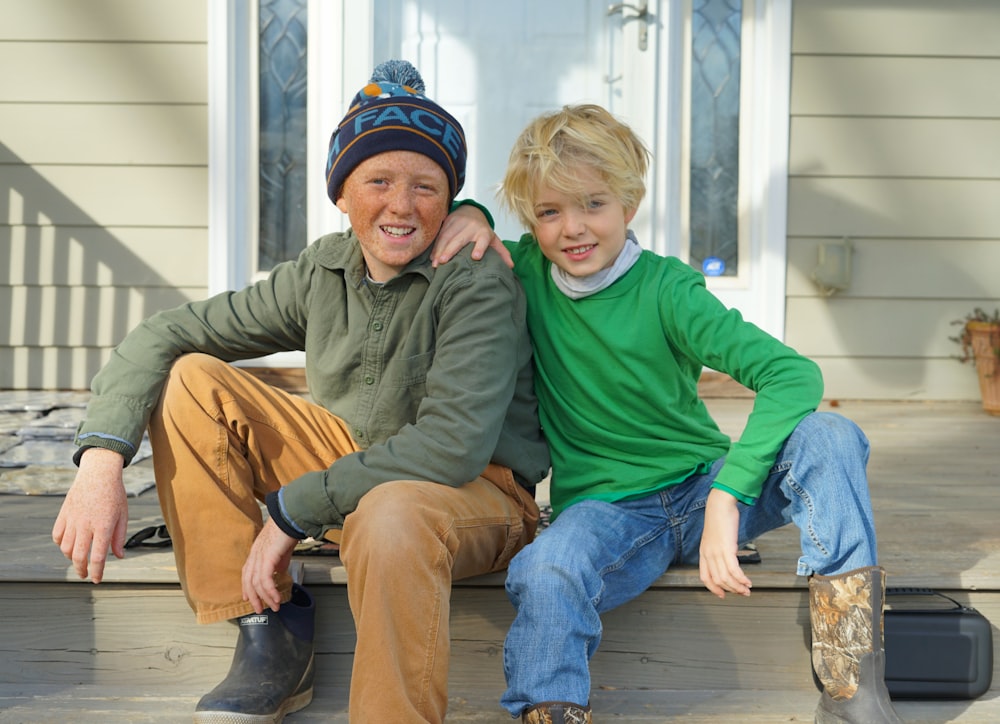 a man and a boy sitting on a porch