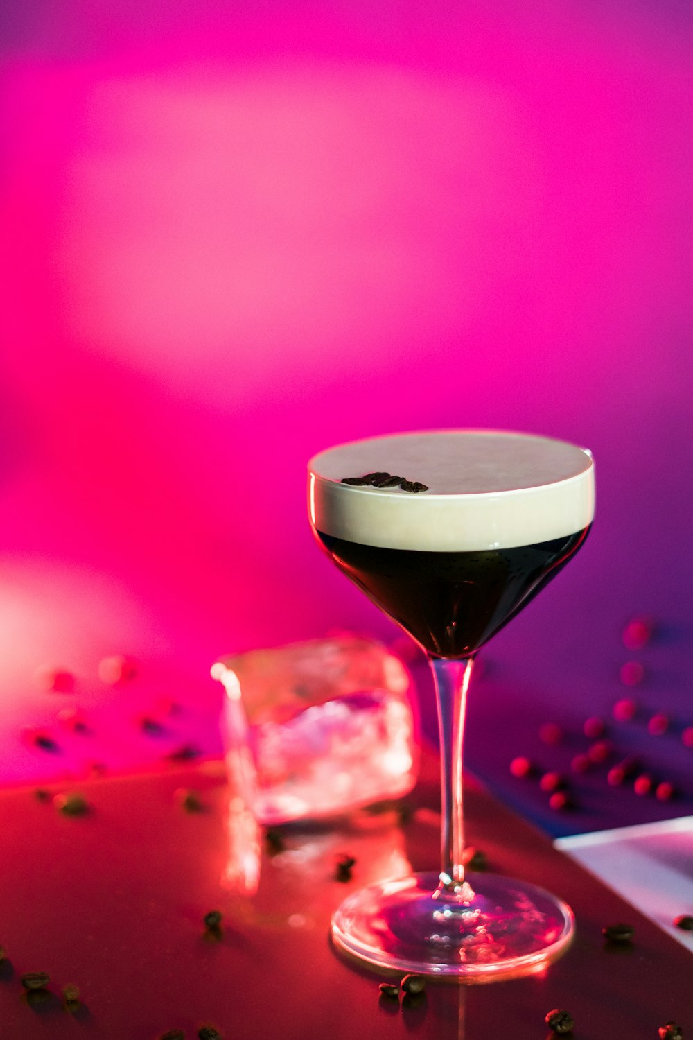 a glass filled with a liquid sitting on top of a table