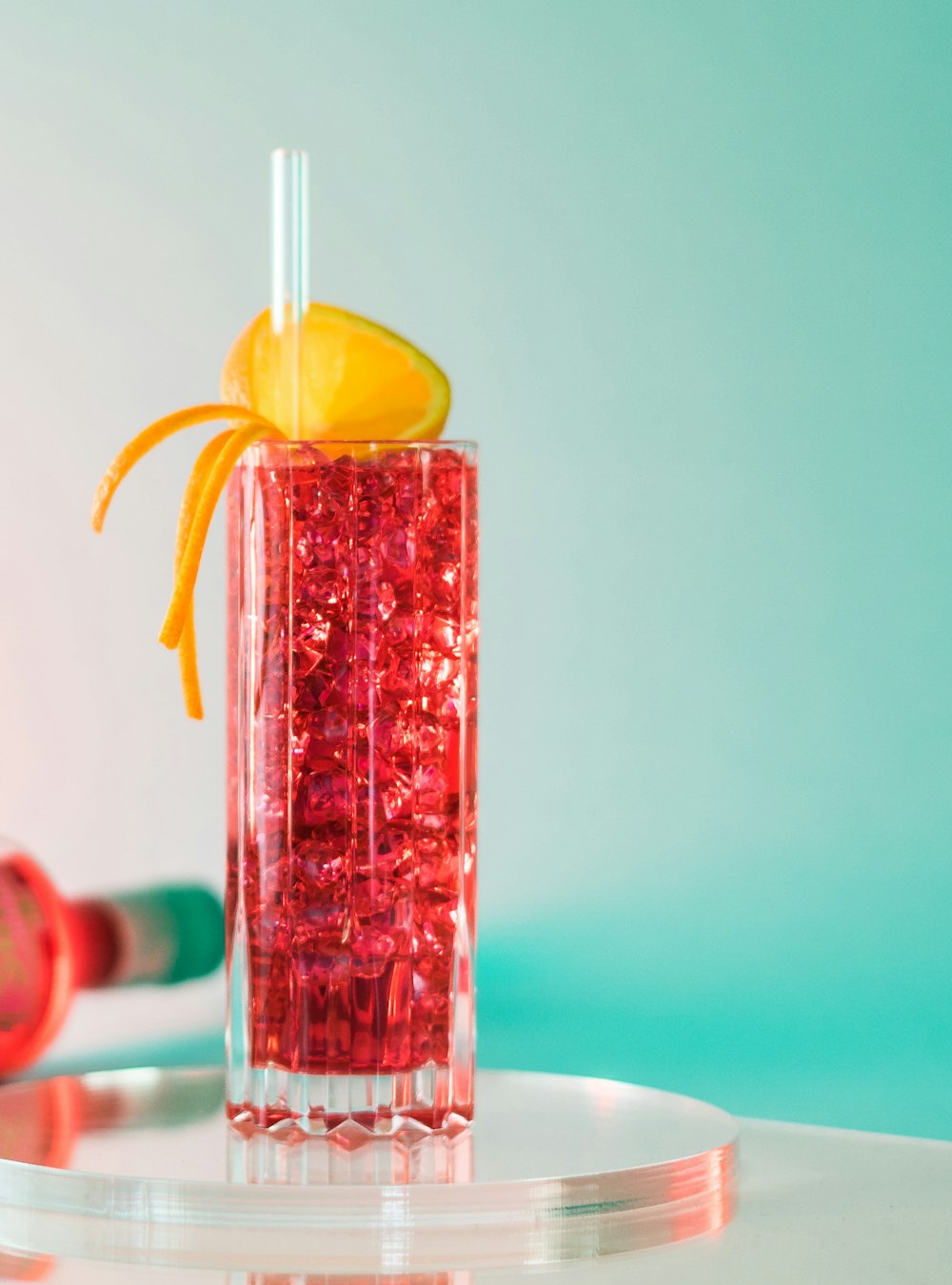 a glass filled with liquid and a slice of orange